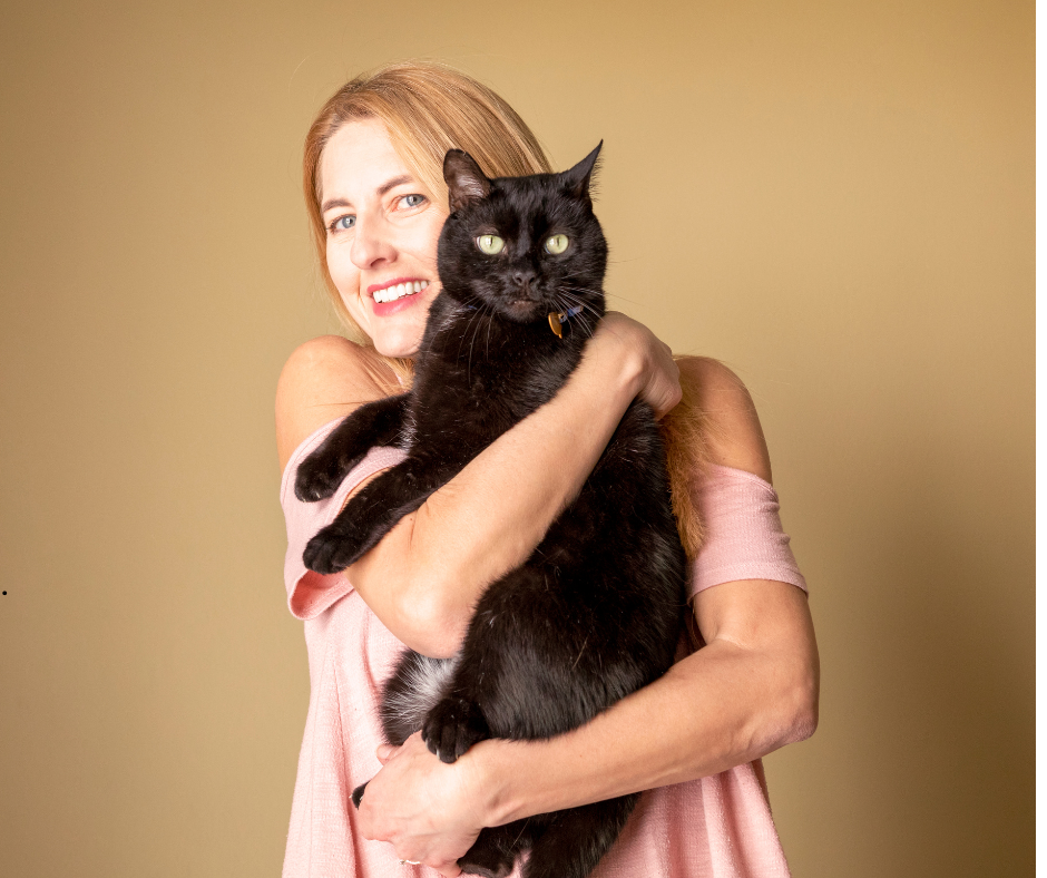 Cat owner embraces black cat on national hug your cat day